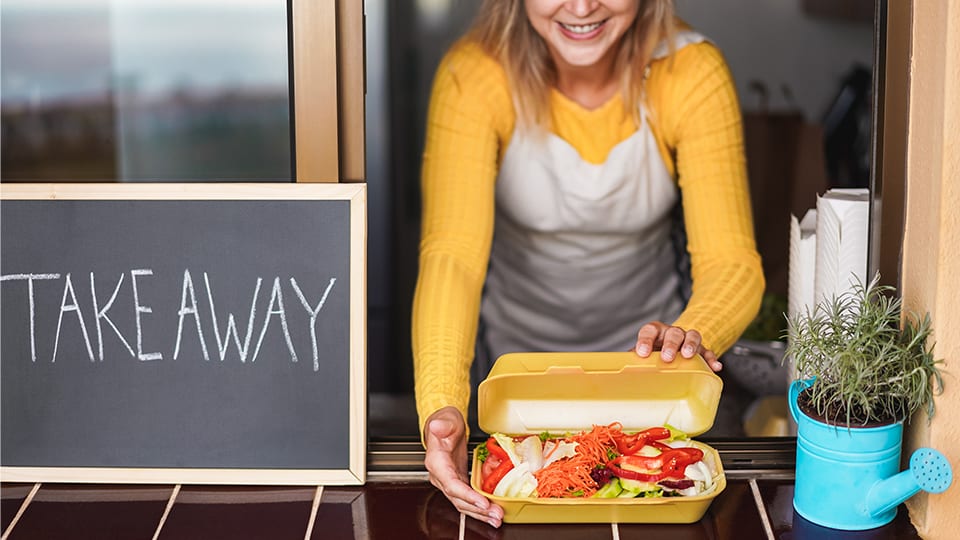 Smiling business owner of takeaway restaurant. Help us gain insight into your business vibe